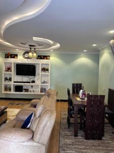 a living room with a couch and a table at Villa maasai in Kimana