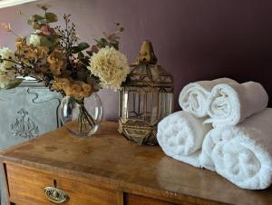 a table with a vase of flowers and a lantern at Compton House, Llanfyllin in Llanfyllin