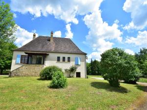 a house on a grassy field with a blue sky at Labardamier Garden Home in Villefranche-du-Périgord