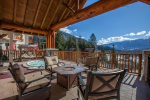 a patio with chairs and a table on a deck at Coast Hillcrest Hotel in Revelstoke
