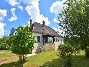 a small white house on a hill with trees at Labardamier Garden Home in Villefranche-du-Périgord