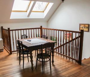 a dining room table with chairs and a skylight at Dom gościnny w Bartniku in StrÃ³Å¼e +9 photos