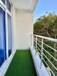a balcony with green flooring in a house at softlife home vale in Nyali