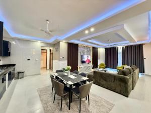 a living room with a couch and a table at softlife home vale in Nyali