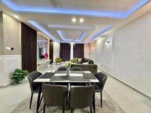 a dining room with a table and a couch at softlife home vale in Nyali