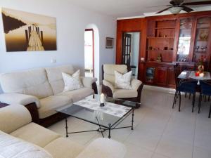 a living room with couches and a coffee table at Apartamento Sole mit Meerblick in Puerto del Carmen