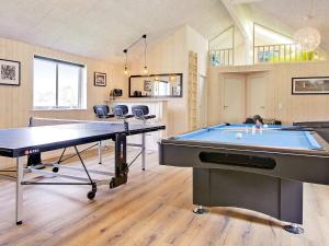 a room with a pool table and a ping pong table at 5 star holiday home in Kappeln in Kappeln