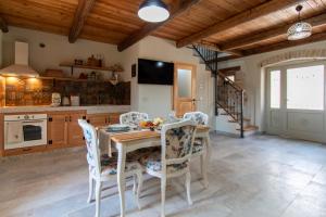 a kitchen with a wooden table and chairs at Casa Morosina in Svetvinčenat