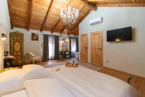 a bedroom with a large bed and a flat screen tv at Casa Morosina in Svetvinčenat