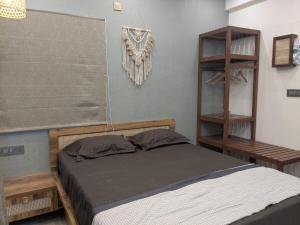a bedroom with a bed and a book shelf at Poolside Farm Retreat wit Garden in Hosūr +4 photos