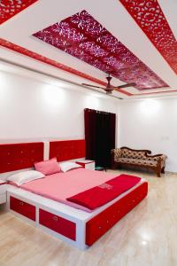 a bedroom with a large red bed in a room at Luxury 4bhk villa with party hall in Chennai