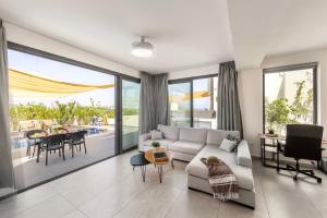 a living room with a couch and a table at Seaside Emerald in Paralimni