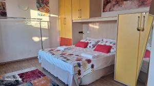 a bedroom with a large bed with red pillows at Riflessi di Mare-Marsala in Marsala