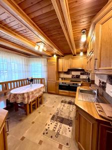 a large kitchen with a table in the middle of it at Смерековий двір in Slavske
