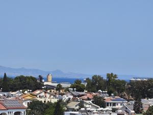 a city with houses and the ocean in the background at Şadan City Inn in Famagusta