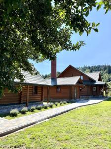 a log house with a chimney on the roof at Смерековий двір in Slavske