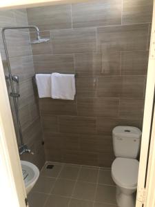 a bathroom with a toilet and a sink at Quốc Ân Motel in Long Hai +80 photos