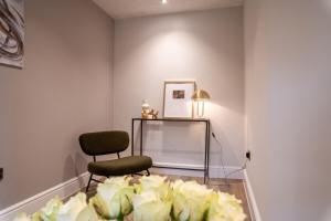 a room with two chairs and a table and a mirror at Cosy 1BR Flat- private parking in Newport