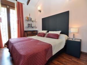 a bedroom with a large bed with a large black headboard at Luxury Villa Near Costa Blanca in Algorfa