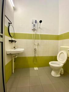 a bathroom with a toilet and a sink at Hanah Home Muar II Wi-fi Coway in Muar