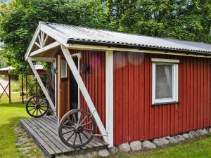 a red shed with a large wheel on a ramp at 6 person holiday home in BENGTSFORS-By Traum in Näs