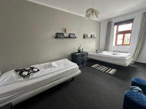 a bedroom with two beds and a window at Kvildahotel in Kvilda