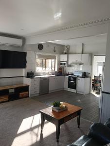 a large kitchen with a table in a living room at Ocean views in Portland +20 photos