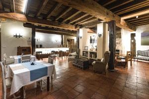 a large room with a table and chairs in it at Posada Rural La Piñorra in Vinuesa