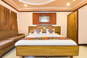 a bedroom with a large bed and a couch at FabHotel Jai Mangal Palace - Sindhi camp bus stand, Jaipur railway station,Sindhicamp metro station in Jaipur +25 photos