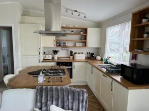 a kitchen with a table and a counter top at Lodge in St Merryn in Saint Merryn