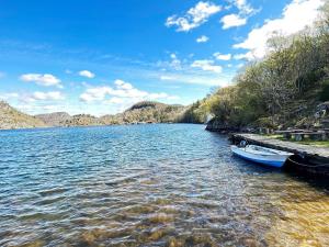 a river with two boats in the water at 5 person holiday home in FARSUND-By Traum in Helle