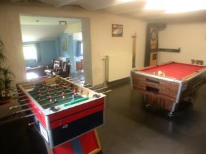 a room with a foos ball and a pool table at Grand Family Farmhouse in Anthisnes in Anthisnes