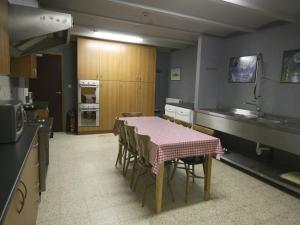 a kitchen with a table and chairs in a kitchen at Grand Family Farmhouse in Anthisnes in Anthisnes