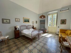 a bedroom with a bed and a couch at Villa Del Prete in Nardò