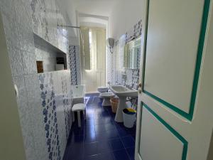 a bathroom with two toilets and a sink and a door at Villa Del Prete in Nardò +73 photos