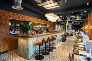 a restaurant with a bar with stools at Second Nature Southampton in Southampton
