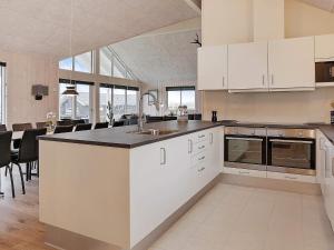 a kitchen with white cabinets and a counter top at 5 star holiday home in Faaborg in Faaborg