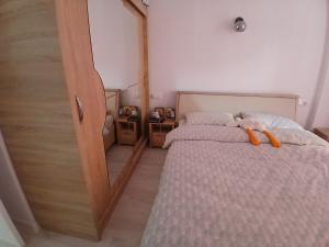 a bedroom with a bed with a stuffed animal on it at Apartament in Ploieşti