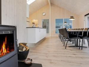 a living room with a fireplace and a table and chairs at 5 star holiday home in Faaborg in Faaborg