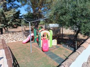 a playground with a slide in a park at Borgo Incanto in Acquaviva delle Fonti