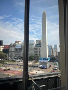 a view from a window of a city with a tower at Corazón obelisco 4 in Buenos Aires