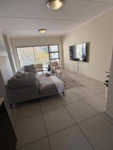 a living room with a couch and a table at Greenstone ridge in Johannesburg