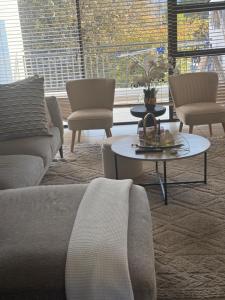 a living room with a couch and chairs and a table at Greenstone ridge in Johannesburg