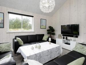 a living room with a couch and a table at 5 star holiday home in Blåvand in Blåvand