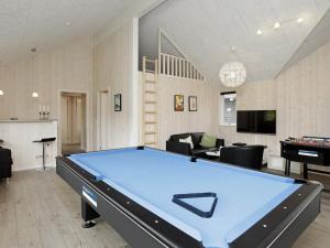 a living room with a pool table in it at 5 star holiday home in Blåvand in Blåvand +33 photos