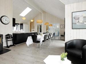 a dining room and kitchen with a table and chairs at 5 star holiday home in Blåvand in Blåvand
