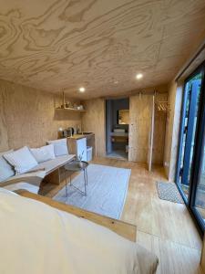 a room with a couch and a table at Bastu Bicheno Tiny home in Bicheno