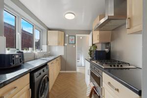 a kitchen with a sink and a stove top oven at New Flat, Parking, 3 Bedrooms, Sleeps 6 in Elswick