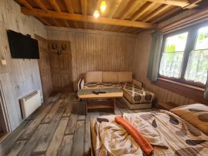 a room with two beds and a tv in a cabin at Agroturistika Borončo in Zázrivá