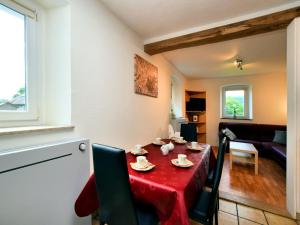 a dining room with a red table and chairs at Holiday Home in Saint Vith with Terrace in Schoenberg